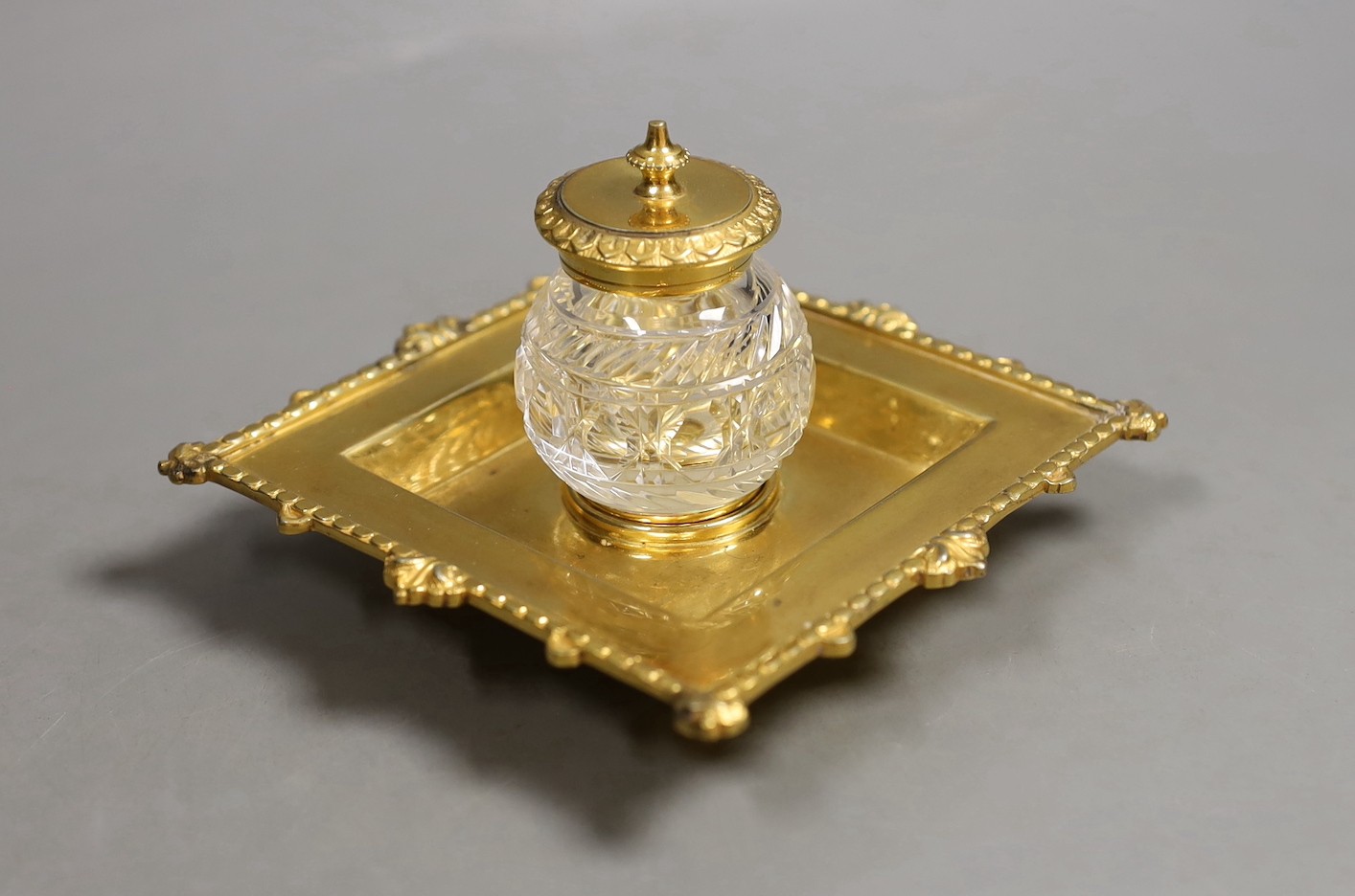 A gold plated inkstand, 7 cms high.